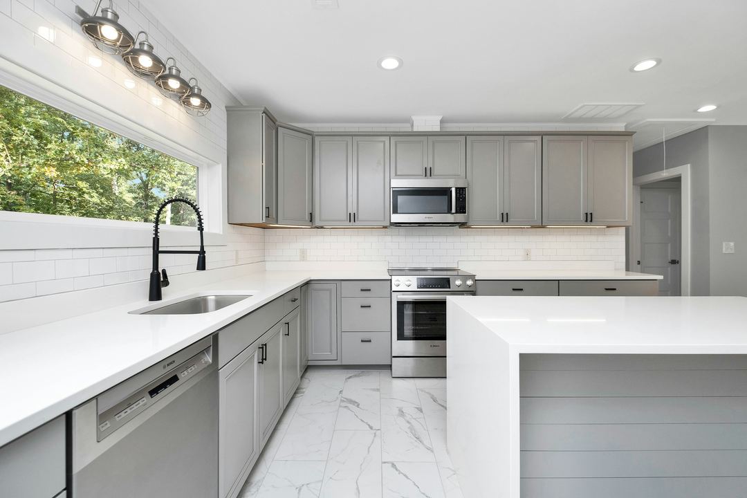 A gray Shaker kitchen with a white island